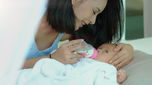 Young Asian single mother with her new born baby 05