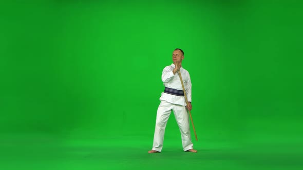 Masculine Kendo Master on White Kimono Warrior Practicing Martial Art with the Bamboo Bokken on