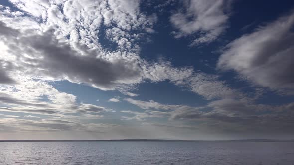 Bright Neat Cloud Fragments Above the Lake