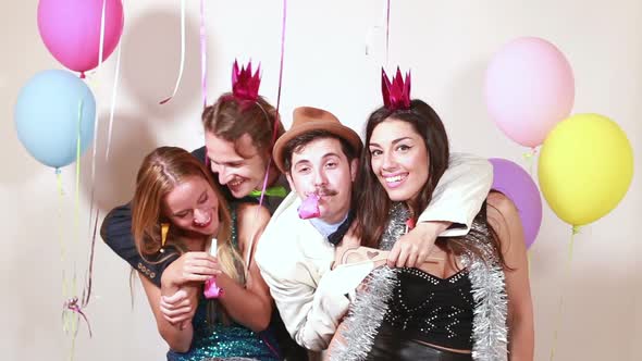 Group of funny crazy friends in photo booth