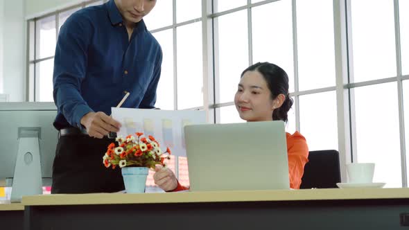 Two Business People Talk Project Strategy at Office