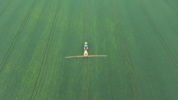 Aerial view of farming tractor crop sprayer in the countryside