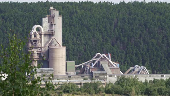 Opencast mining quarry with machinery and mining equipment. Limestone mining for cement production.