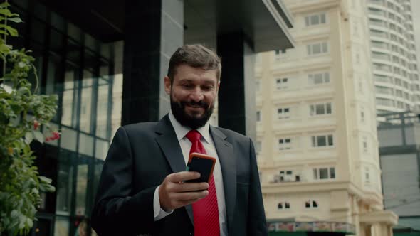 A Man is Talking on a Cell Phone in the Street