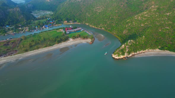 4K aerial view of mountain coast near beautiful beach and sea. Flight over sea.