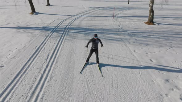 Cross Country Skier Skiing Along Snowy Path