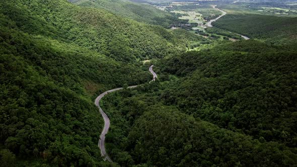 Logistic concept aerial view of countryside road - motorway passing through the serene lush greenery