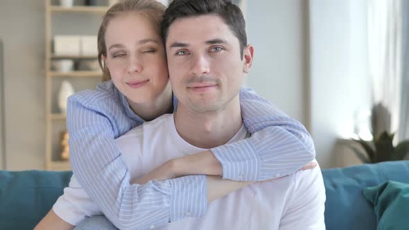 Young Couple in Hug Looking at Camera