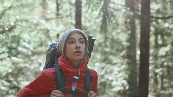 Slow Motion Woman Hiker Attractive Happy Young Woman in Red Insulated Jacket with Backpack Hiking in