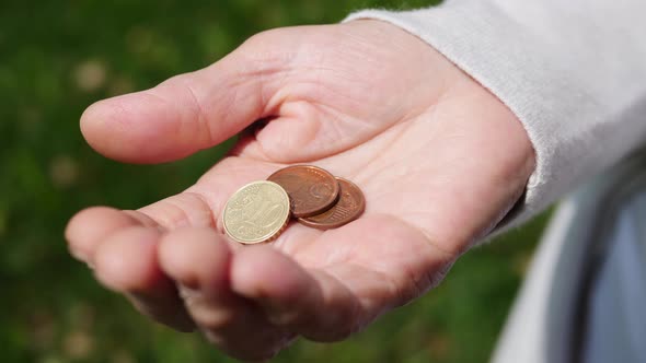 Hands Of Elderly Woman Counting Coins. Close-Up.