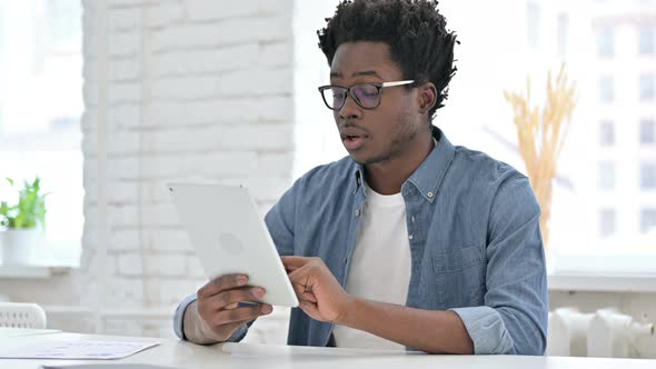 Young African Man Get Surprise on Tablet 