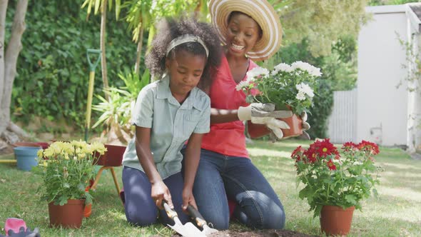 Mother and daughter gardening during a sunny day