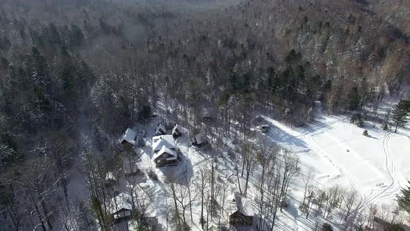 Several Houses in the Middle of the Winter Taiga Frome Drone