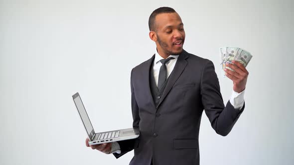 Professional African-american Business Man Holding Laptop Computer and Cash Money