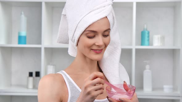 Portrait Domestic Girl in Towel Mixing Moisturizing Mask