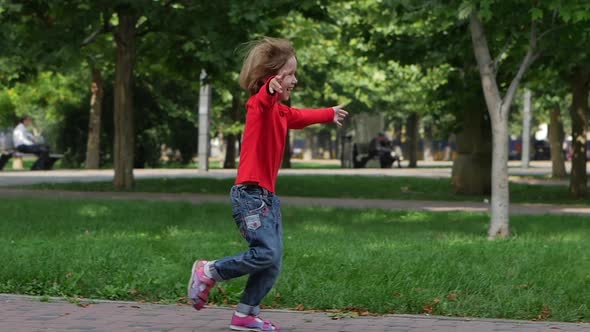 Child Running Into Mother's Hands To Hug Her. Slow Motion