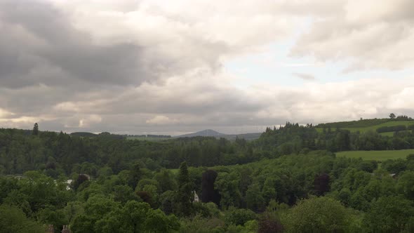 Scottish Landscape covered in Woodland and Farmhouses