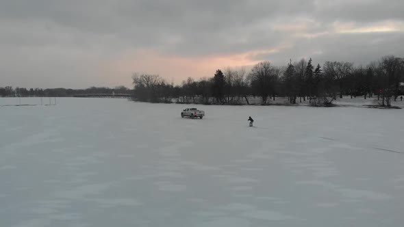 skiing on ice pulled by a truck