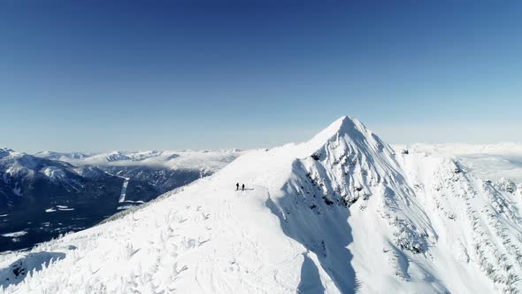 Skiers standing on a snow capped mountain 