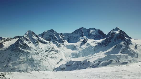 Aerial drone view of snow covered mountains in the winter.