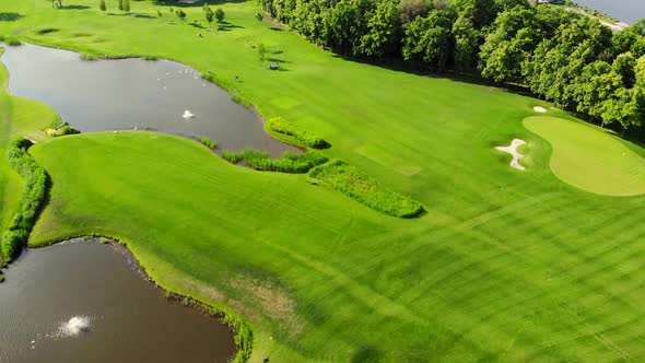 Wide Green Golf Field with Artificial Ponds