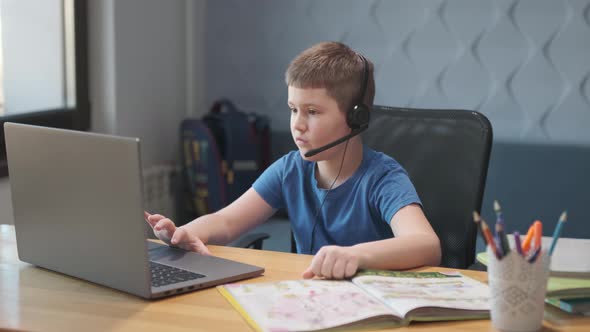 Portrait of boy learning online at home. Closeup child using laptop computer sitting at table