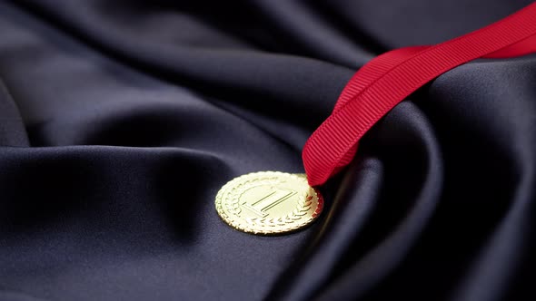 Gold Medal with Ribbon on Black Background Closeup