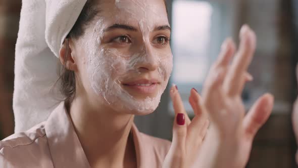 Girlfriends Applying Clay Mask On Each Other Faces