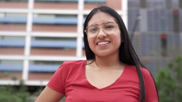 Portrait of Carefree Hispanic Latin American Young Woman Smiling in the City