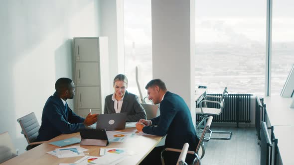 Young multiracial business people enjoying working together at office