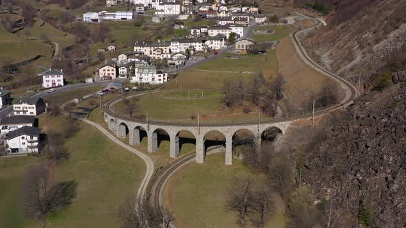 Train on Brusio Spiral Viaduct in Switzerland