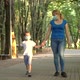 Mother and Son in Medical Masks Walk in the Park - VideoHive Item for Sale
