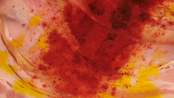 Macro shot of red pepper powder on ham and olive oil combination. Close up shot of red spice sprinkl