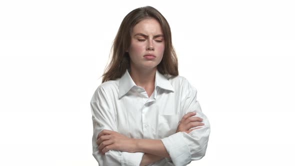 Closeup of Attractive Young Woman with Short Hairstyle Wearing White Shirt Looking Offended and