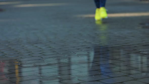 Female Sports Woman Jogging Outdoors Stepping Into Puddle