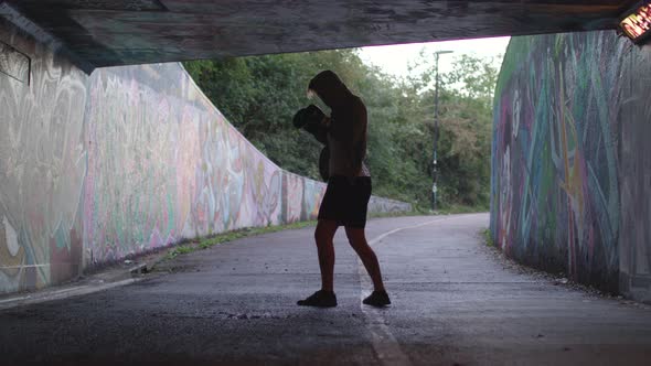 Wide Shot of Young Attract Man Boxing In Underpass, In Slow Motion.