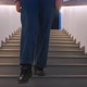 A Young Woman Walks Down the Stairs Closeup - VideoHive Item for Sale