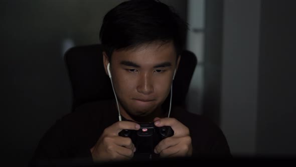 young man using joystick to playing games