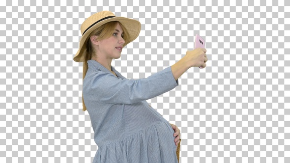 Charming pregnant woman in a hat making selfie, Alpha Channel