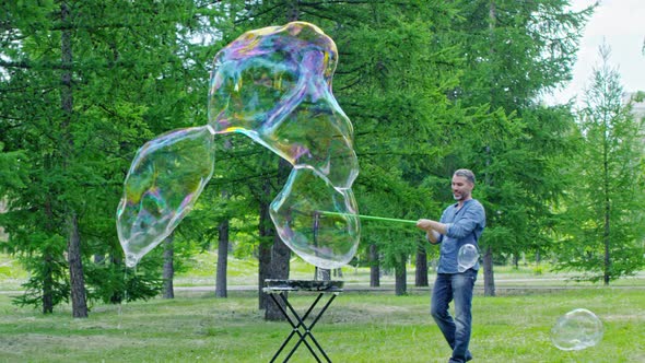 Professional Performer Blowing Large Bubbles in the Park