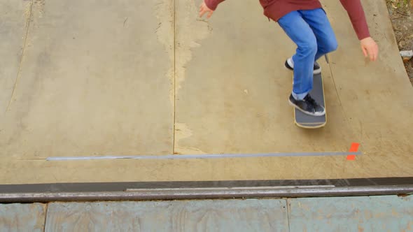 High angle view of young man doing skateboard trick on skateboard ramp at skateboard court 4k