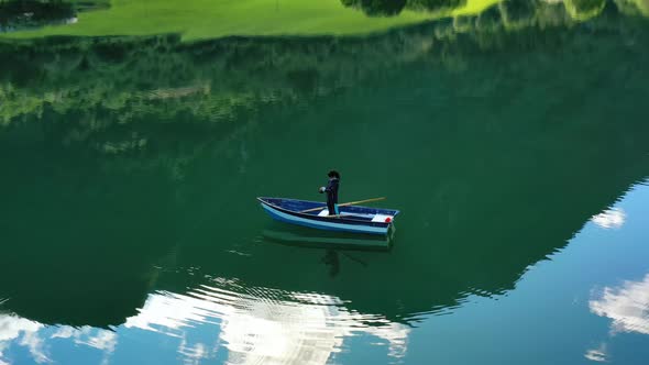 Woman on the Boat Catches a Fish on Spinning in Norway