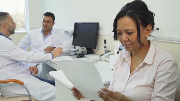 A Satisfied Patient Studies Her Medical Certificate