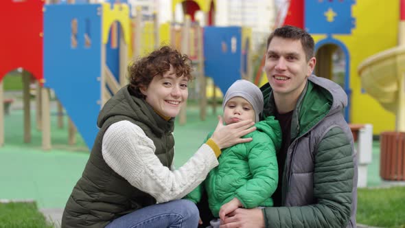 Young Caucasian Parents and Son Posing in Playground alt