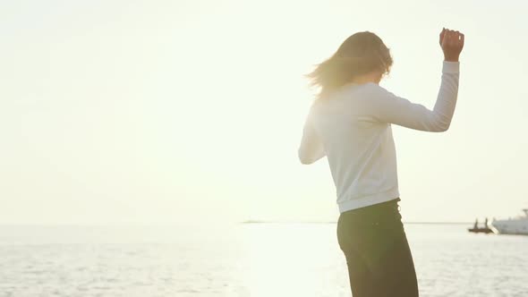 Charming Woman Is Posing on the Beach.