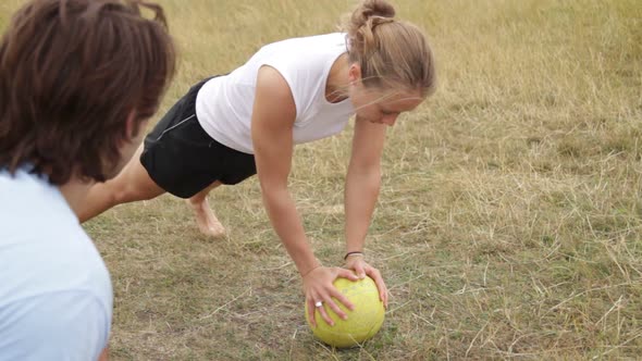 Female being coached by personal trainer in park