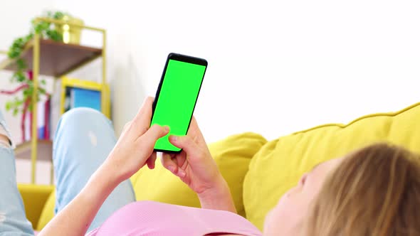 Phone with Green Screen Chroma Key in Hands of Blonde in Pink Top