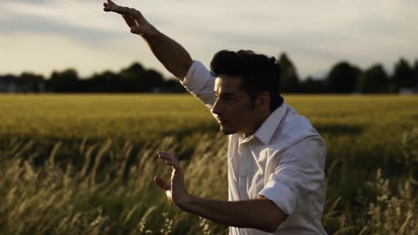 Slow motion shot of young man dancing in nature