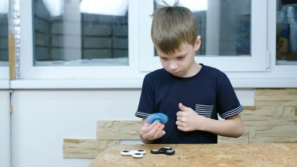 Little Child Playing with Modern Popular Hand Toy - Spinner Spinner Hypnotizing Boy