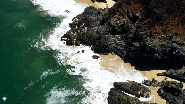 Flock Of Birds Flying Under The Large Beach Rocks On The Seashore Of Playa San Pancho In  San Franci